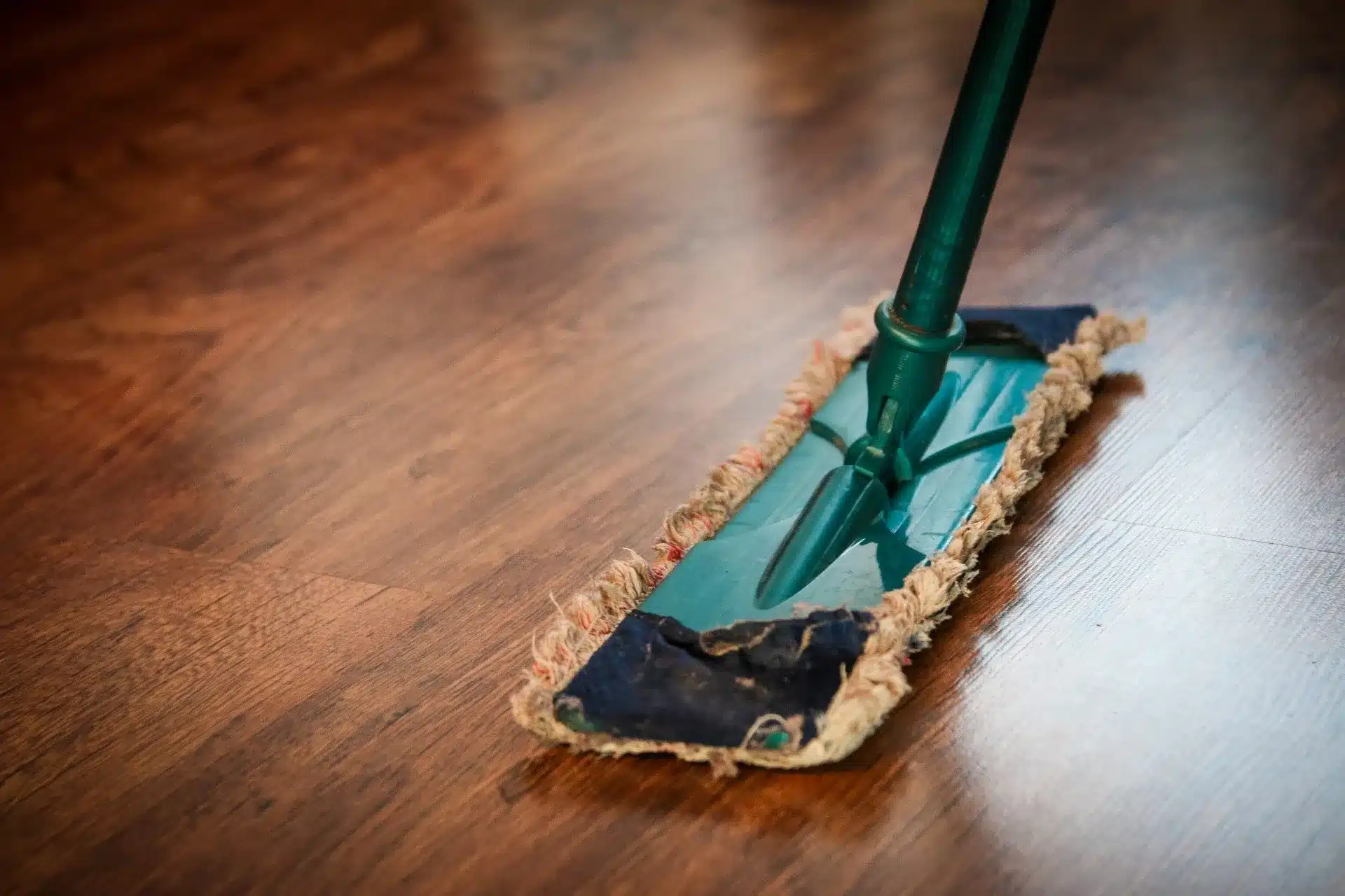 Stripping and waxing floors — dust mop on wood