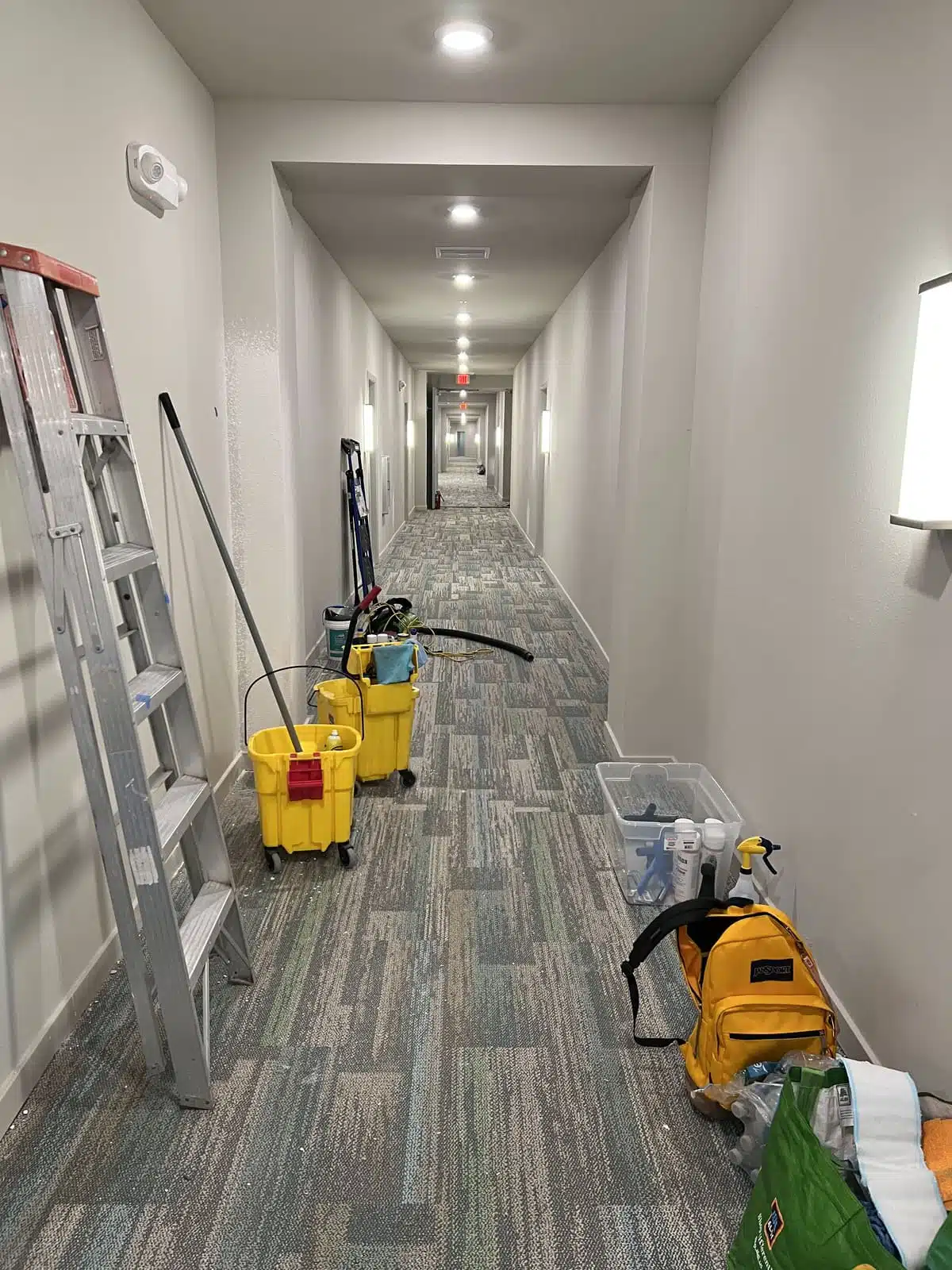 Building hallway with supply carts — janitorial services; day porter
