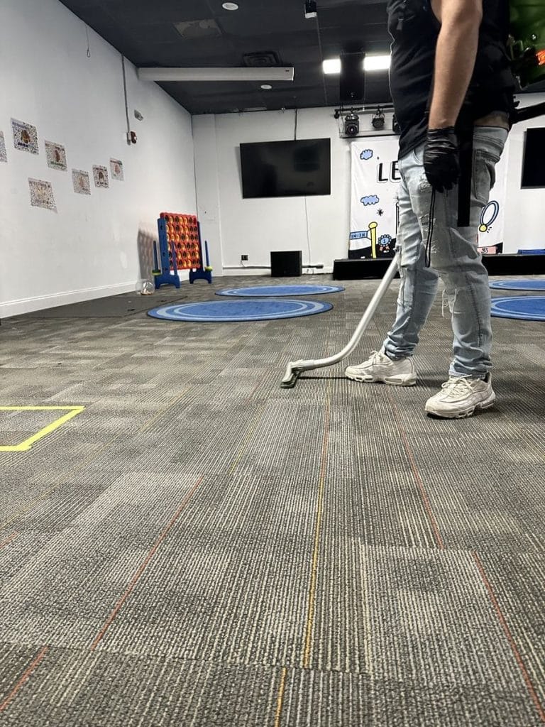 Cleaning classrooms — carpet wand in school room