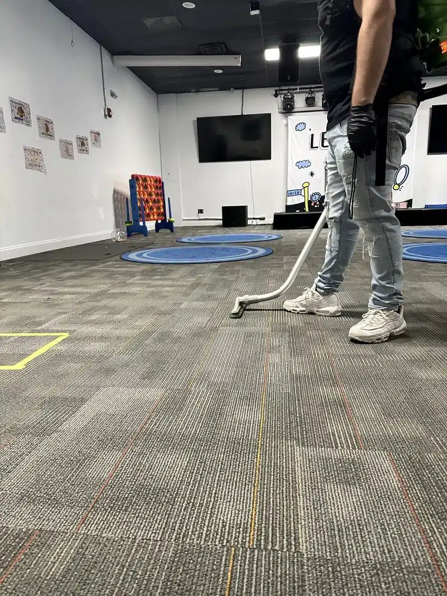 Cleaning classrooms — carpet wand in school room